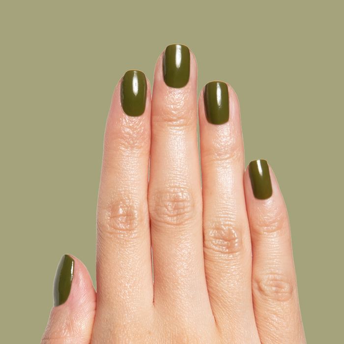 Hand with nails painted in smooth glossy Mossy gel polish showing quick dry manicure on natural nails