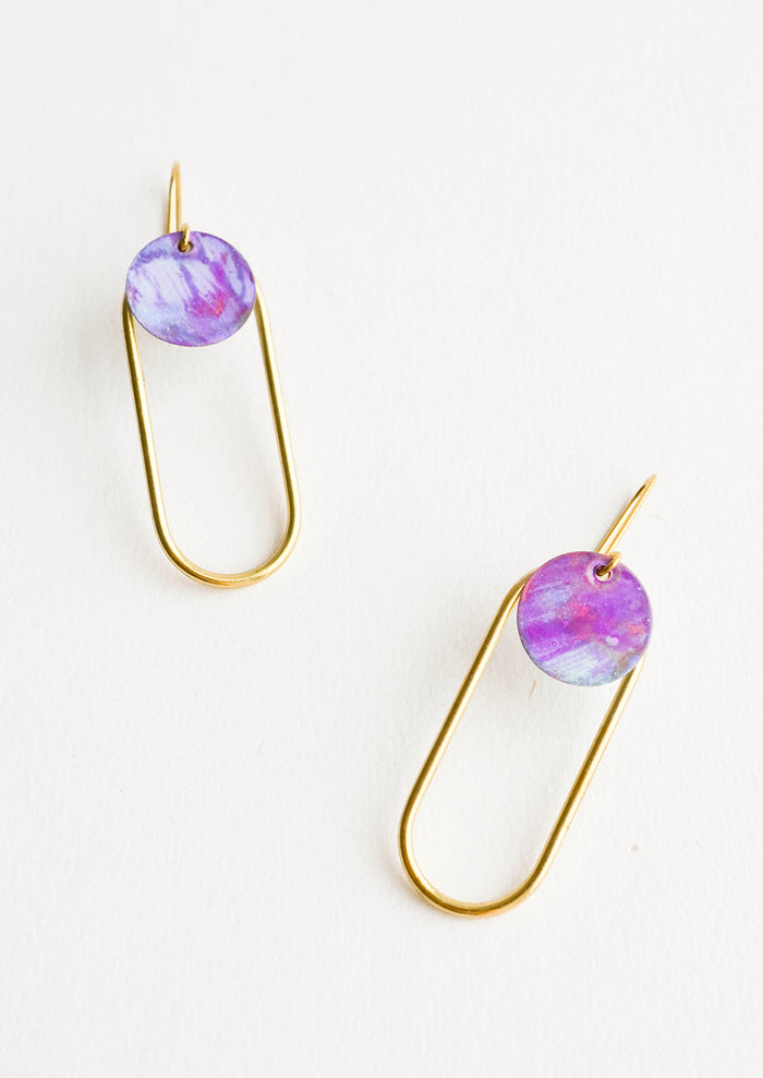 Pair of earrings in the shape of a hollow brass oval with a painted purple dot at the top.