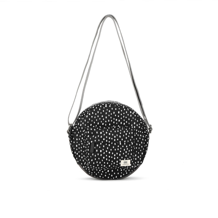 Recycled canvas crossbody bag, round black with white speckle pattern and gray strap