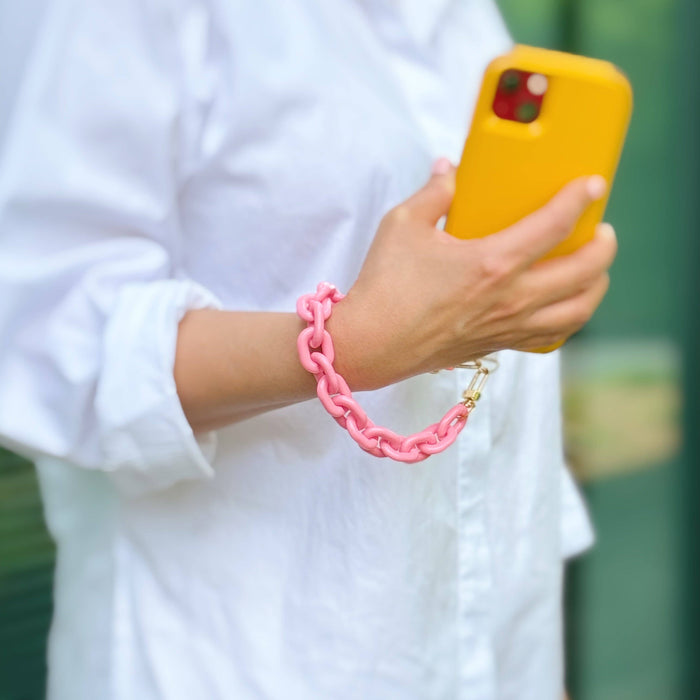 Ellison+Young phone wrist lanyard with adjustable strap and clip, designed to secure smartphones comfortably on the wrist.