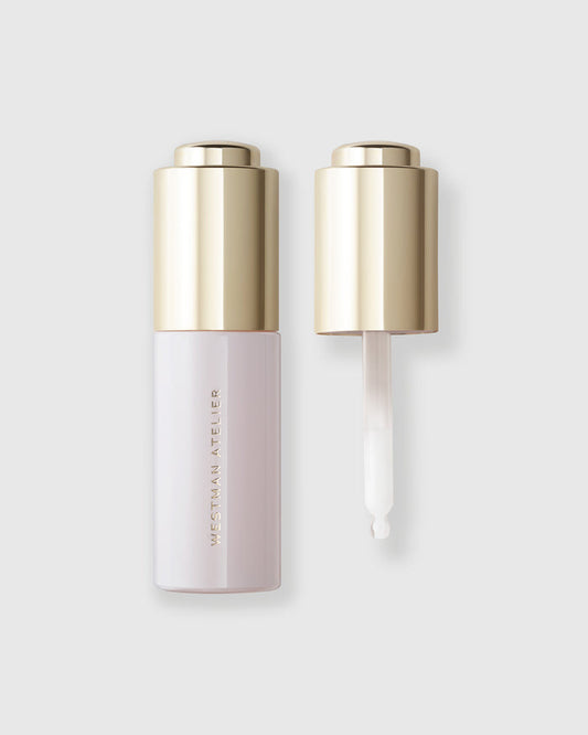 Two skincare bottles with gold caps on a light gray background