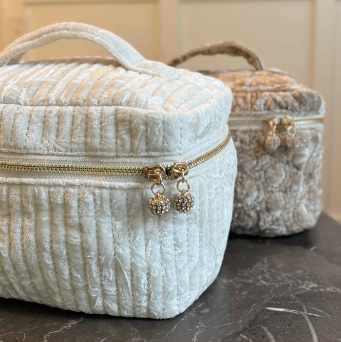 Ellison+Young quilted velvet vanity case with zipper closure, featuring a soft pink interior and elegant stitching details.