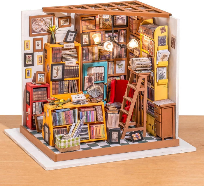 Miniature model of a bookshelf with books and decorative items on a white background 1.24 scale miniature size