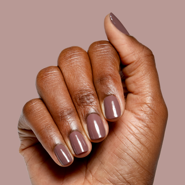 Hand with medium brown skin tone wearing smooth glossy Sable gel polish manicure on natural short nails