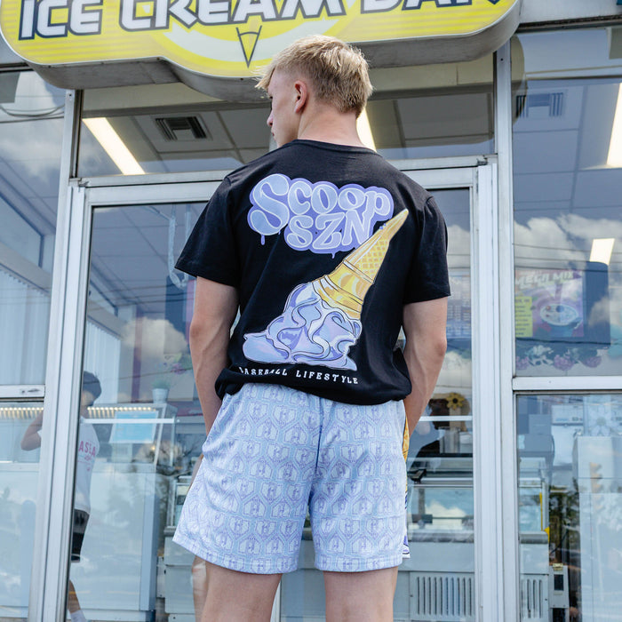 Adult model wearing shorts with "Scoop SZN" design