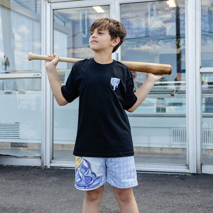 Youth model wearing youth shorts with "Scoop SZN" design