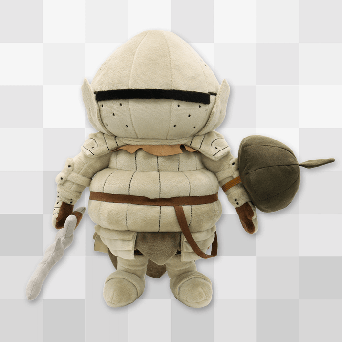 The official Siegmeyer plush against a gray pixellated background, showing its magnetically attached plush sword and elastic-banded plush shield accessories.