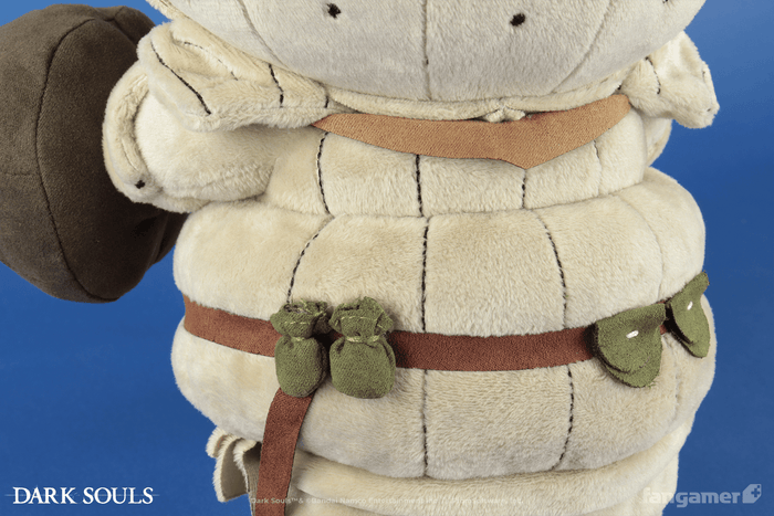 A closeup of the back of the Siegmeyer plush, showing a number of plush pockets and sacks attached to its belt as well as the back of its armor.