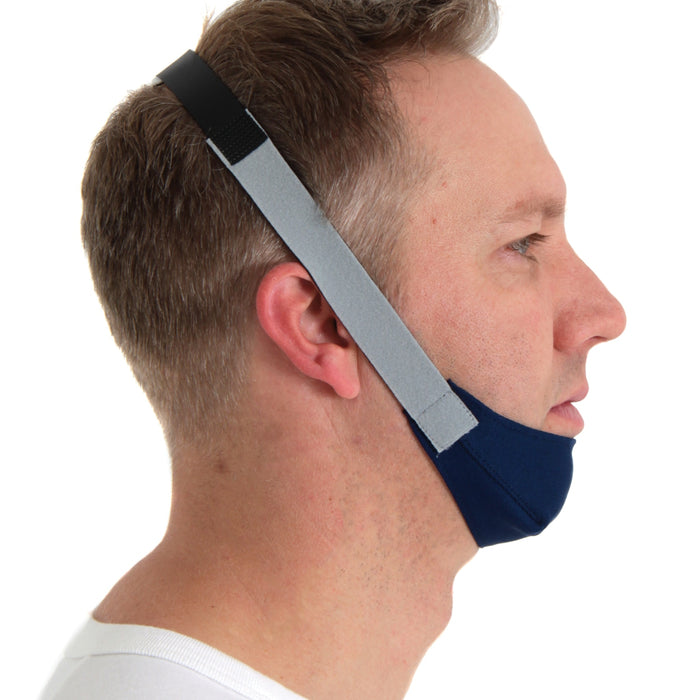 Man wearing a blue and gray chin strap device on a white background