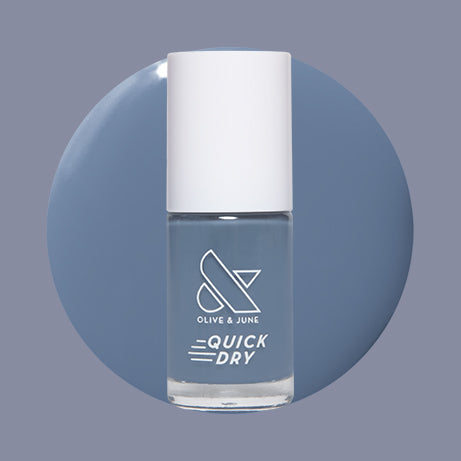 Olive and June Slate quick dry gel polish bottle with muted blue-gray shade on round color swatch background