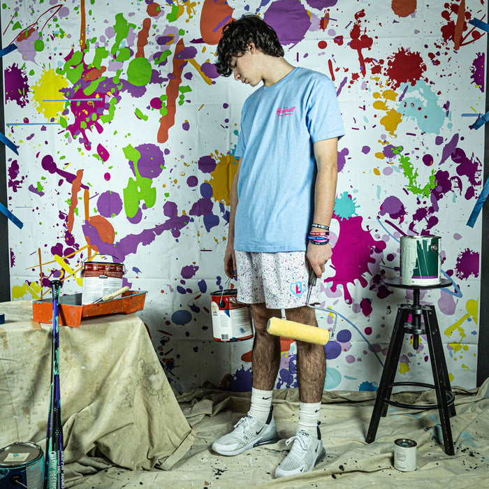 Adult model wearing white shorts with “Splatter” design