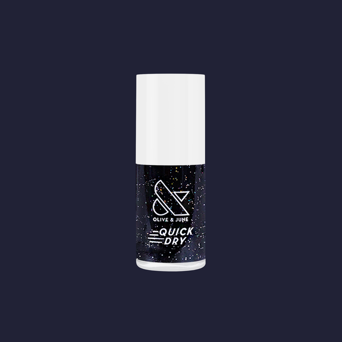 Olive and June Stargaze quick dry polish bottle in inky black with sparkling rainbow glitter on dark blue background