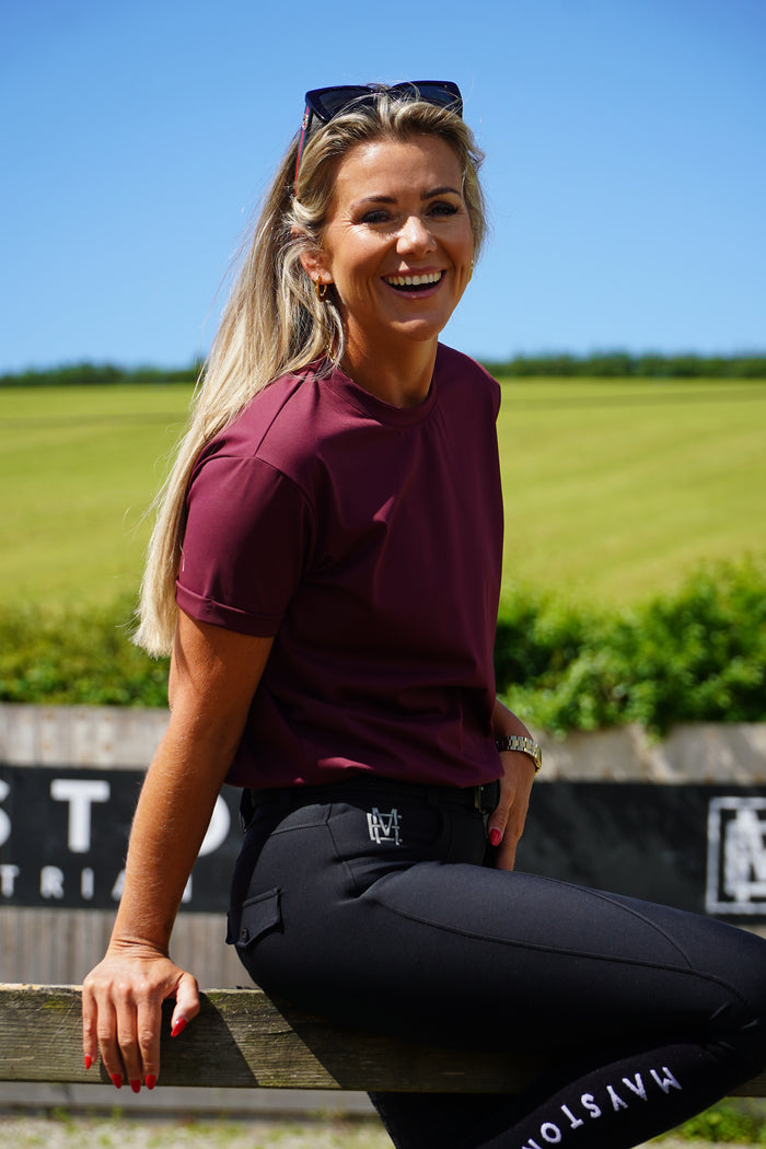 Crafted from a luxuriously soft technical sports fabric in a breathable nylon blend with stretch, it offers a smooth, lightweight feel that moves effortlessly with you — from stable life to everyday wear. Burgundy Short Sleeve tee, high gloss mayston branding