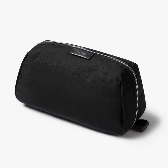 Black toiletry kit with zip-top closure and small brand label