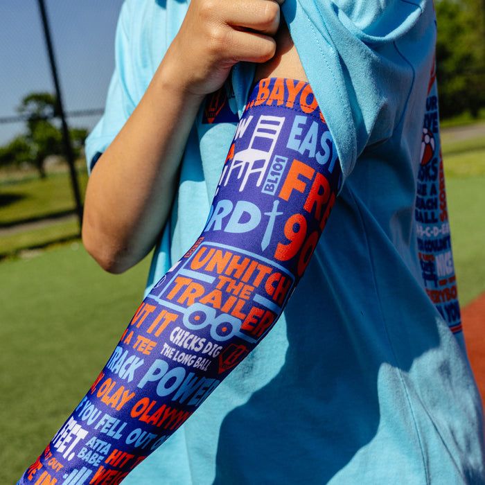 Youth model wearing multi-color youth arm sleeve with "Trash Talk Youth" design