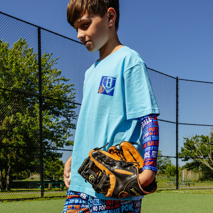 Youth model wearing multi-color youth arm sleeve with "Trash Talk Youth" design