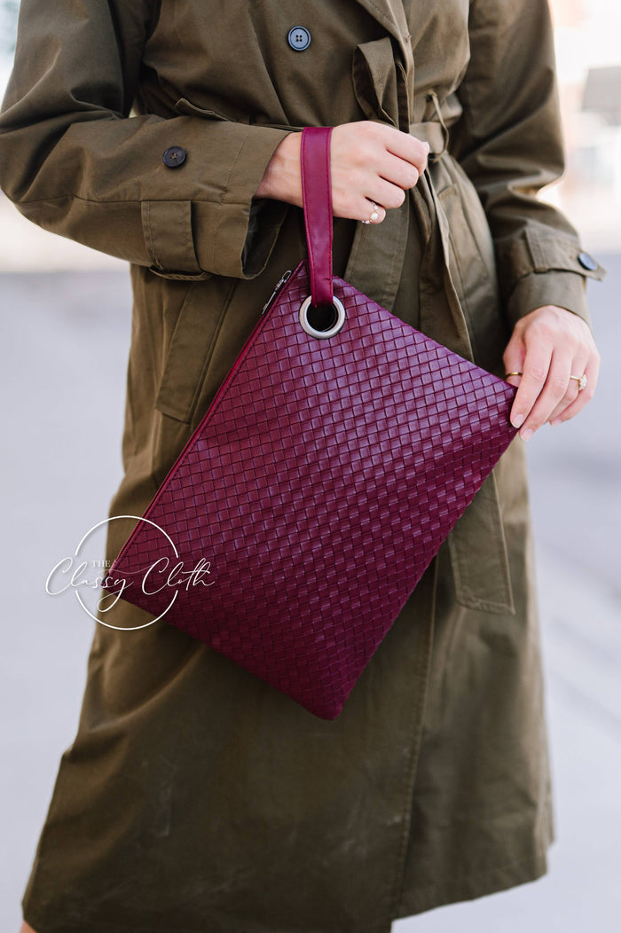 Trendy Weave Wine RTS clutch bag by The Classy Cloth WS with woven design and compact shape, perfect for stylish occasions.