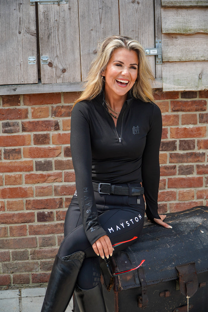 Sleek silhouette baselayer top subtle Mayston branding, maximum coverage without compromising style,  next-level performance with a bold, minimalist look. Moisture-wicking, breathable fabric with four-way stretch, it keeps you cool and comfortable. Training, Everyday or competition wear. longsleeve 1/4 zip with collar. black with black branding