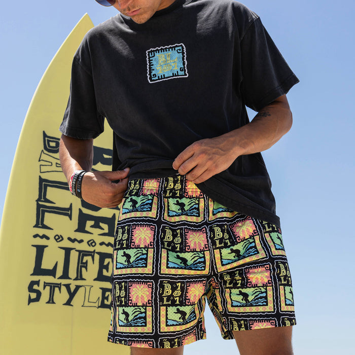 Adult model wearing multi-color shorts with "Wave Goodbye" design