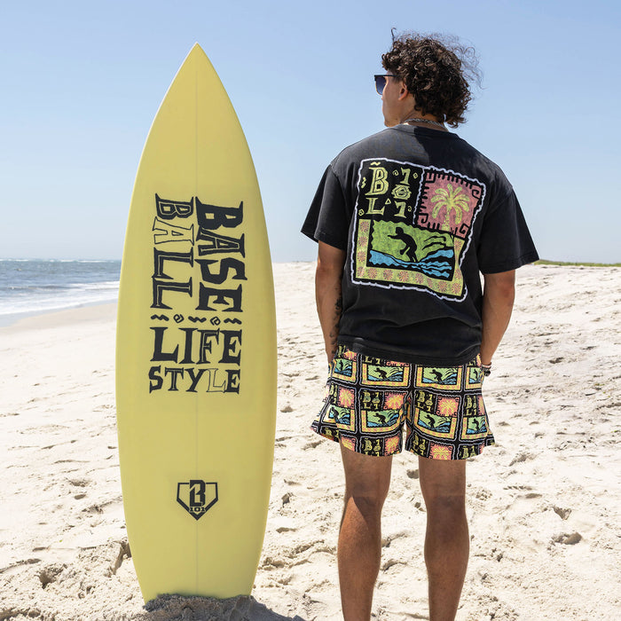 Adult model wearing multi-color shorts with "Wave Goodbye" design