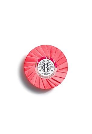 Round pink soap bar with embossed center label and ridged outer design