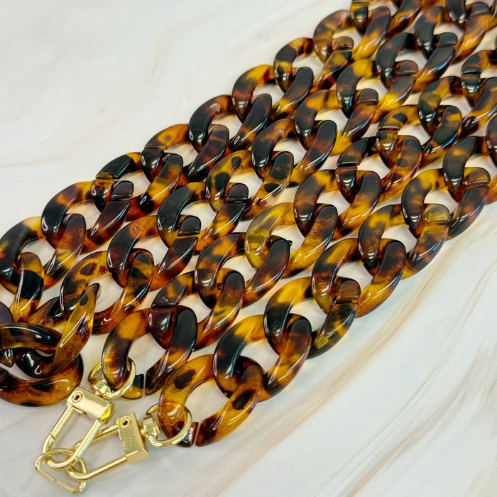 Ellison+Young Wink Phone Lanyard with colorful strap and clip, designed to securely hold a smartphone for easy access.