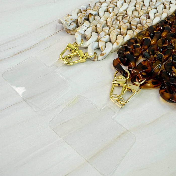 Ellison+Young Wink Phone Lanyard with stylish strap and clip, designed to securely hold and easily access your phone.