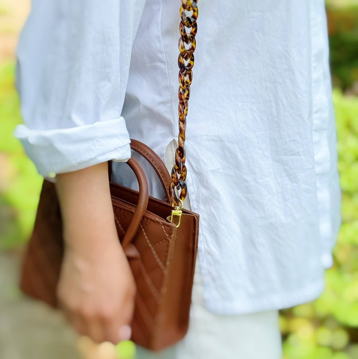 Ellison+Young Wink Phone Lanyard with adjustable strap and metal clasp, designed for secure and stylish phone carrying.