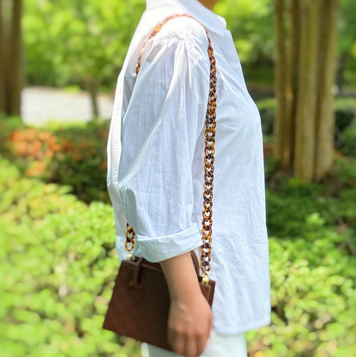Ellison+Young Wink Phone Lanyard with sleek strap and clasp, designed for secure and stylish phone carrying.